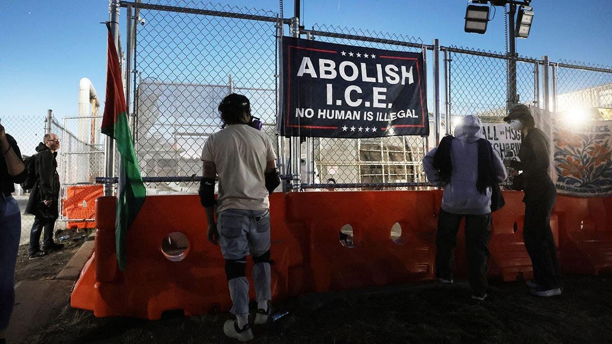 abolish ICE sign hands outside Delaney Hall