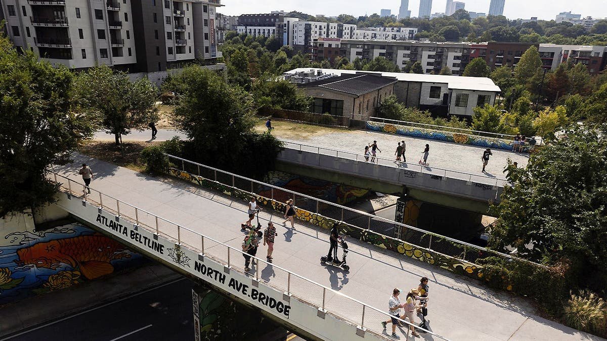 People walk along the Atlanta Beltline in Atlanta, Georgia