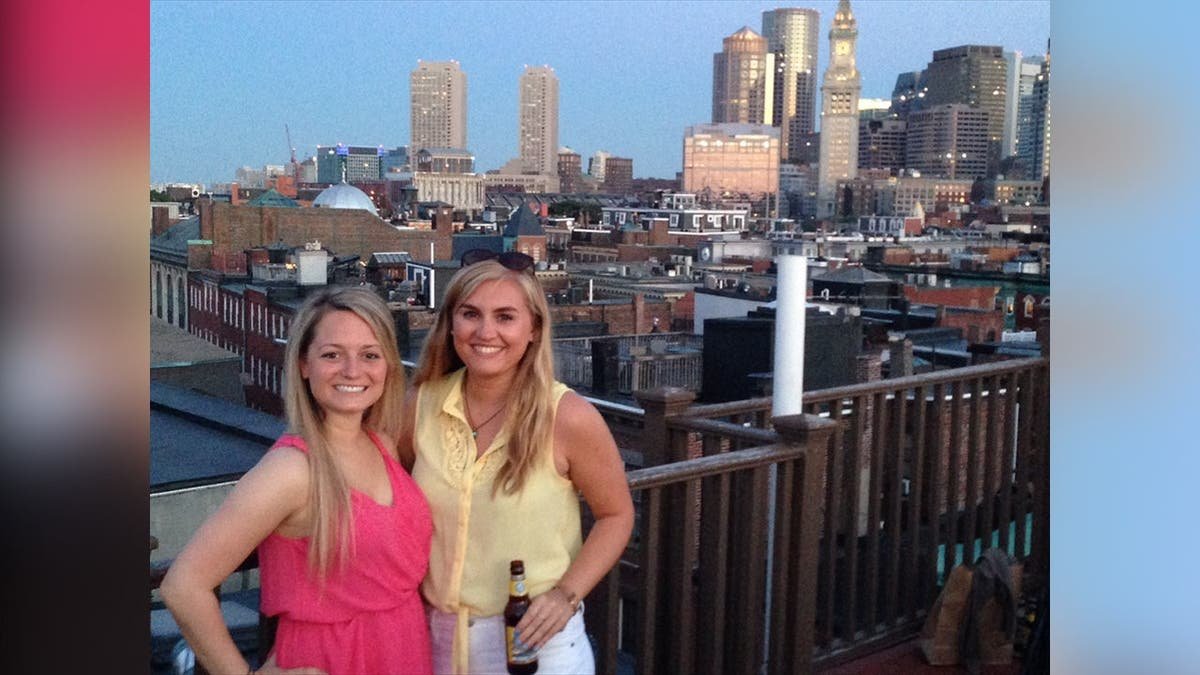 Photo shows girls posing for photo with city skyline