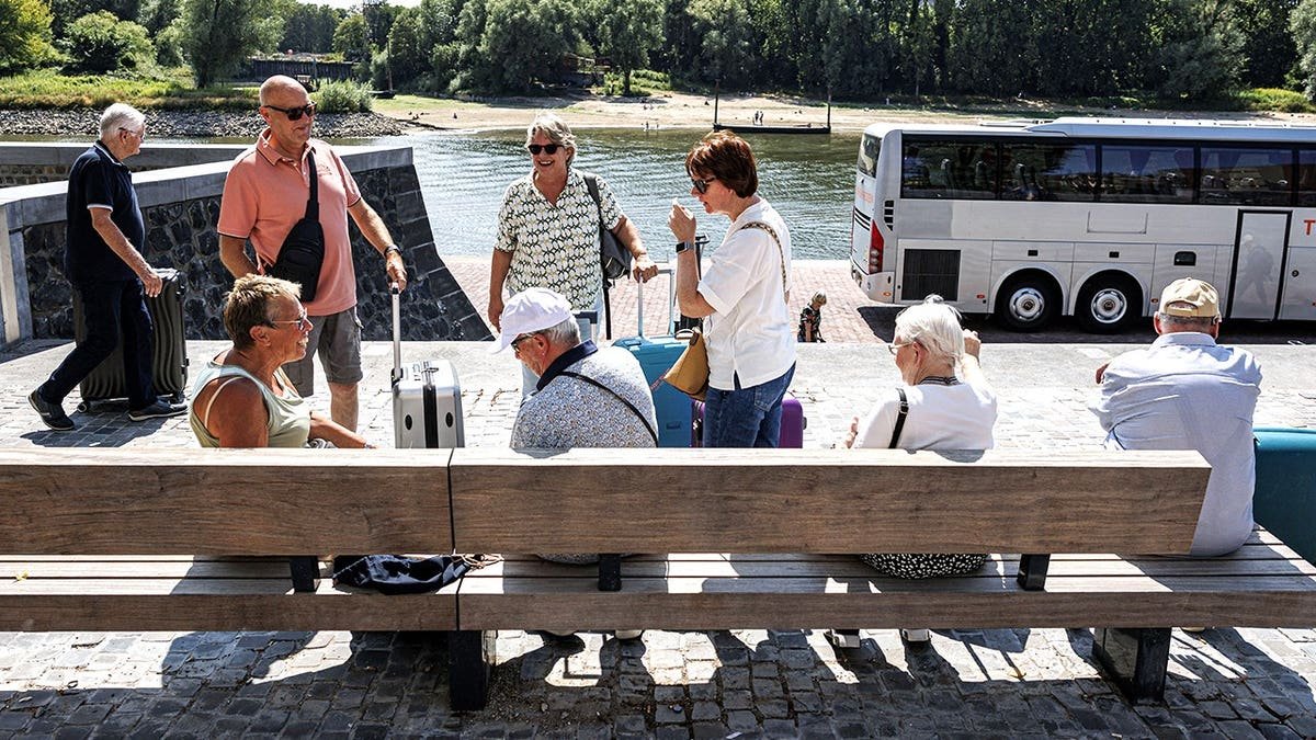 View of cruise passengers being bussed to different locations