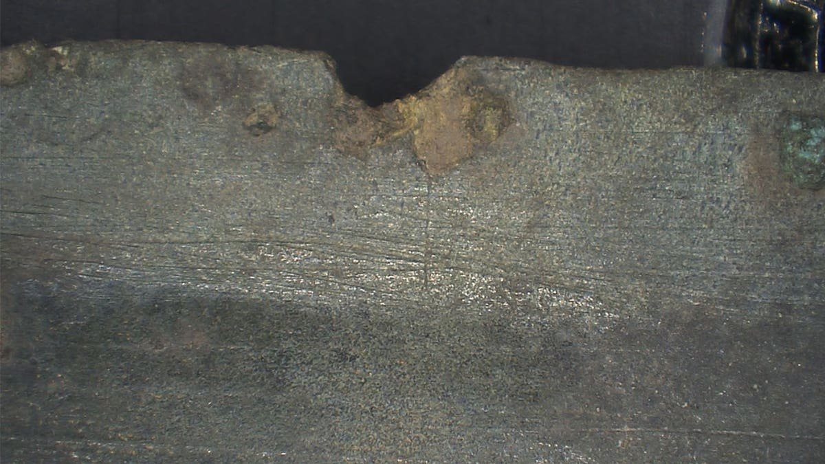 Close-up of damage to ancient sword