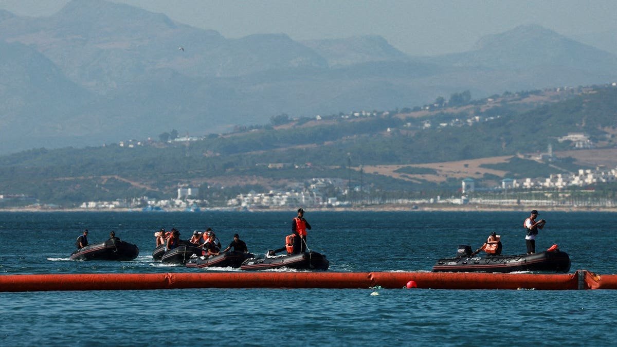 Members of the Royal Moroccan Navy patrol on the Moroccan side of the floating barrier off the border with Morocco, following mass crossings of migrants on foot and by sea from Morocco into Spanish territory, as seen from Ceuta, Spain, August 2, 2026.