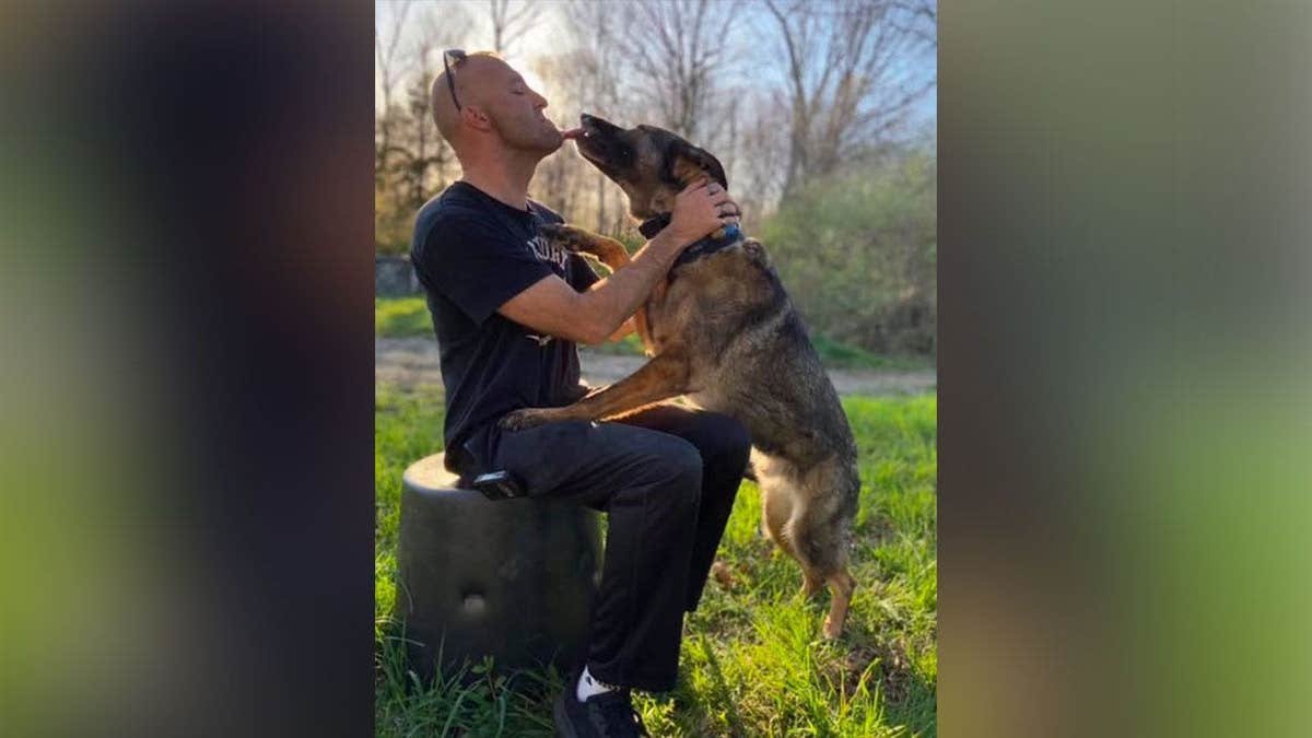 Bridgeport Police Officer Cooper Whiteside poses with his dog in an undated photo before his death in a July 2026 crash.