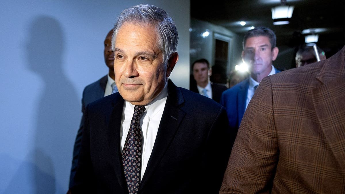 Larry Krasner, Philadelphia's district attorney, center, departs after a hearing at City Hall in Philadelphia, Pennsylvania, US, on Thursday, Oct. 31, 2024.