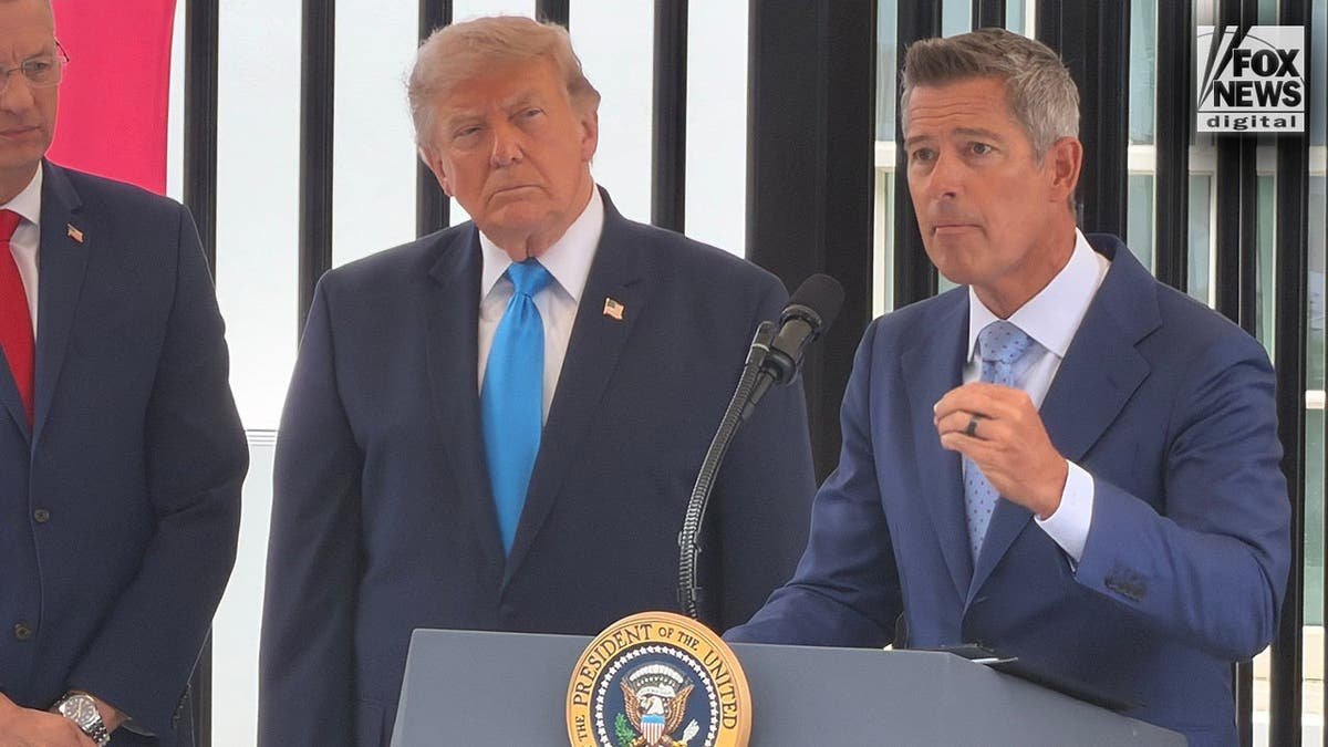Transportation Secretary Sean Duffy speaks as President Donald Trump looks on during the Freedom Haulers announcement.