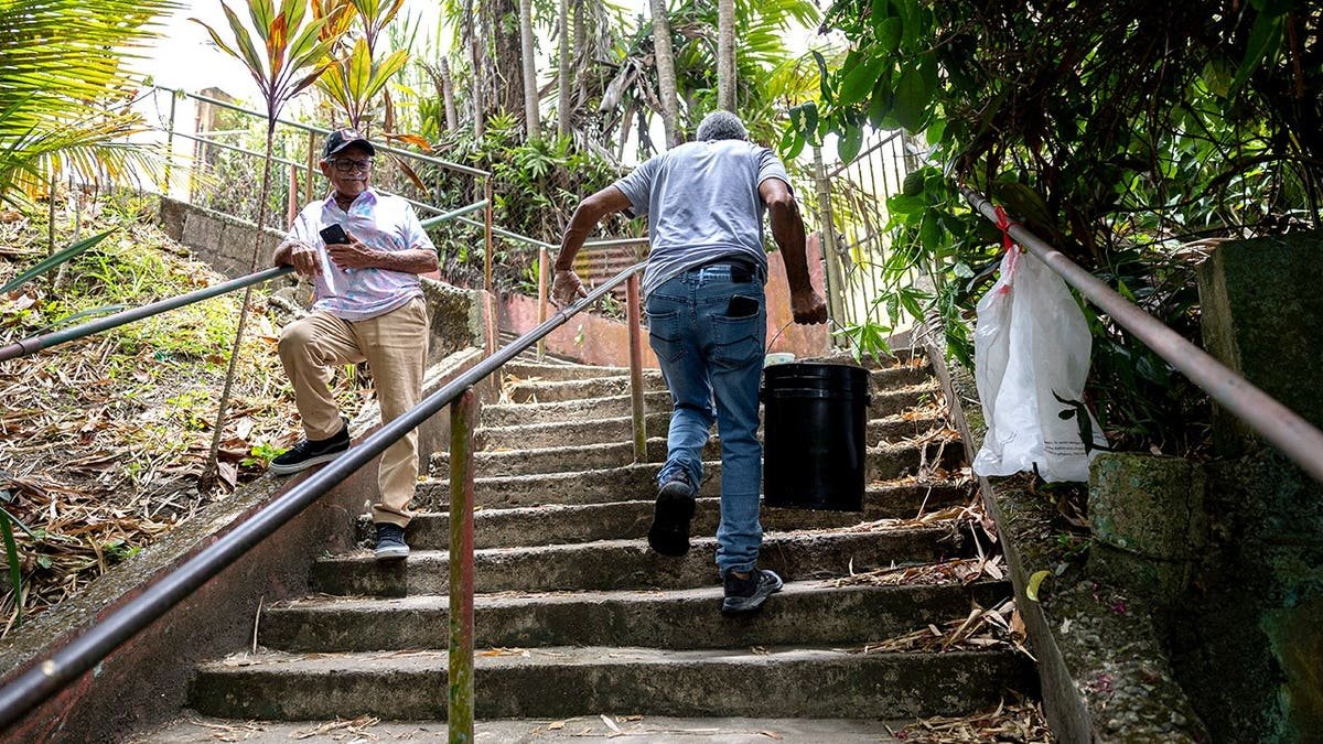 Men carrying water up stairs in Puerto Rico