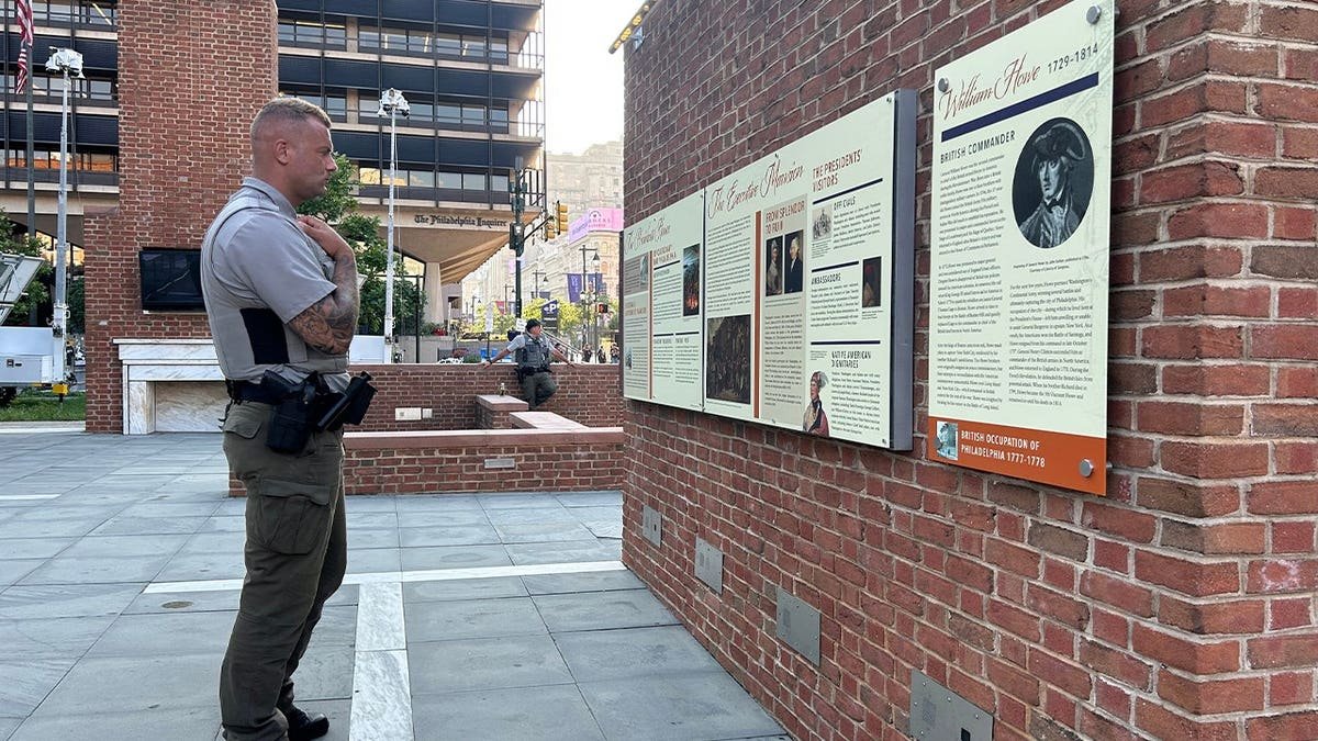 A National Parks Service police officer looks at the displays installed by the Trump administration at the President's House in Philadelphia.