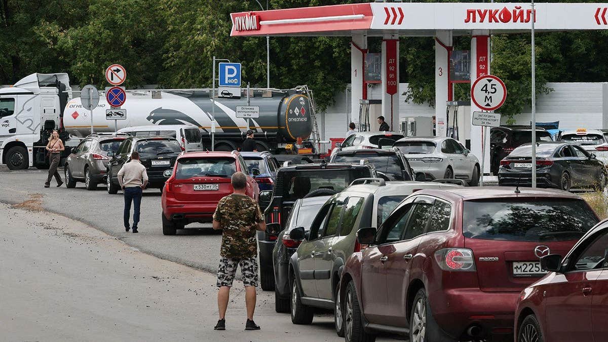 Cars queue to refuel at a Lukoil fuel station in Russia