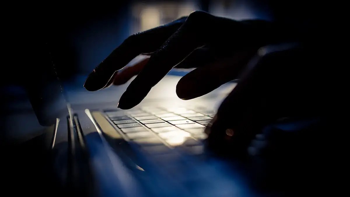 Person typing on their laptop.