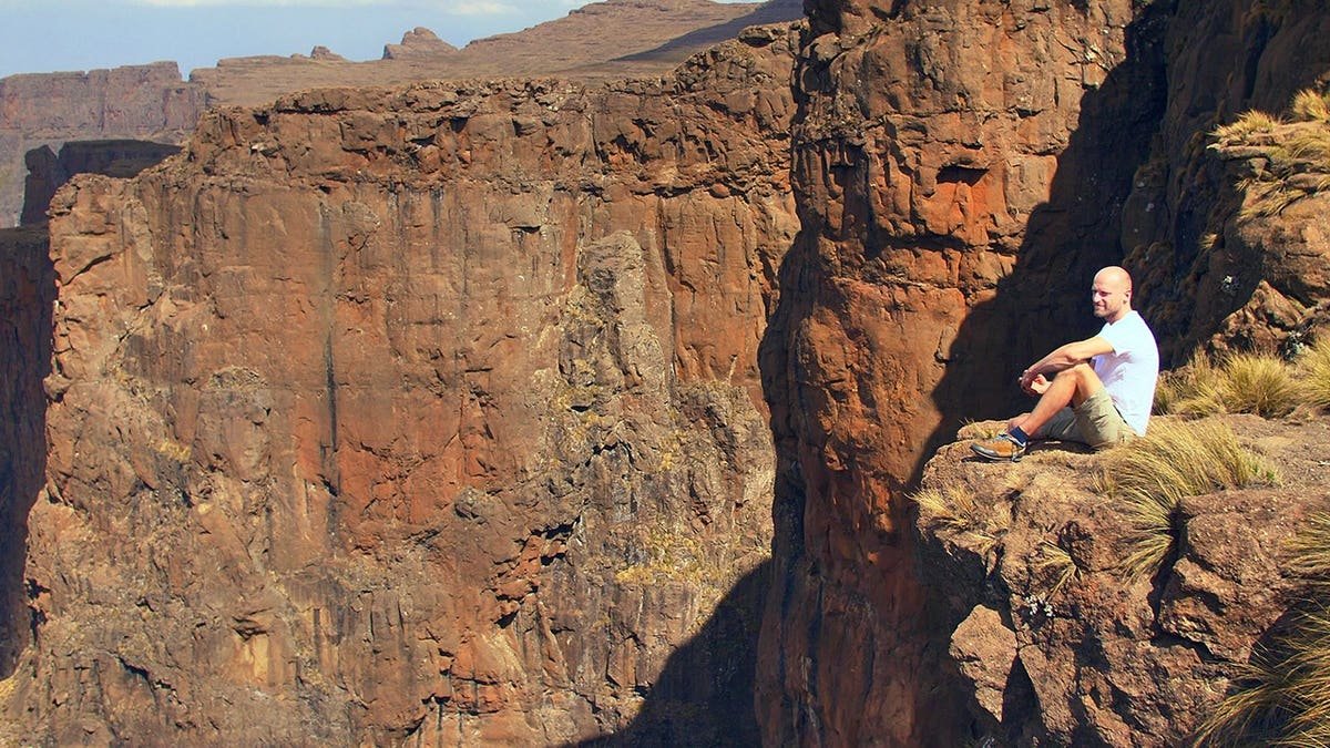 View of hiker sitting on Mozambique cliff