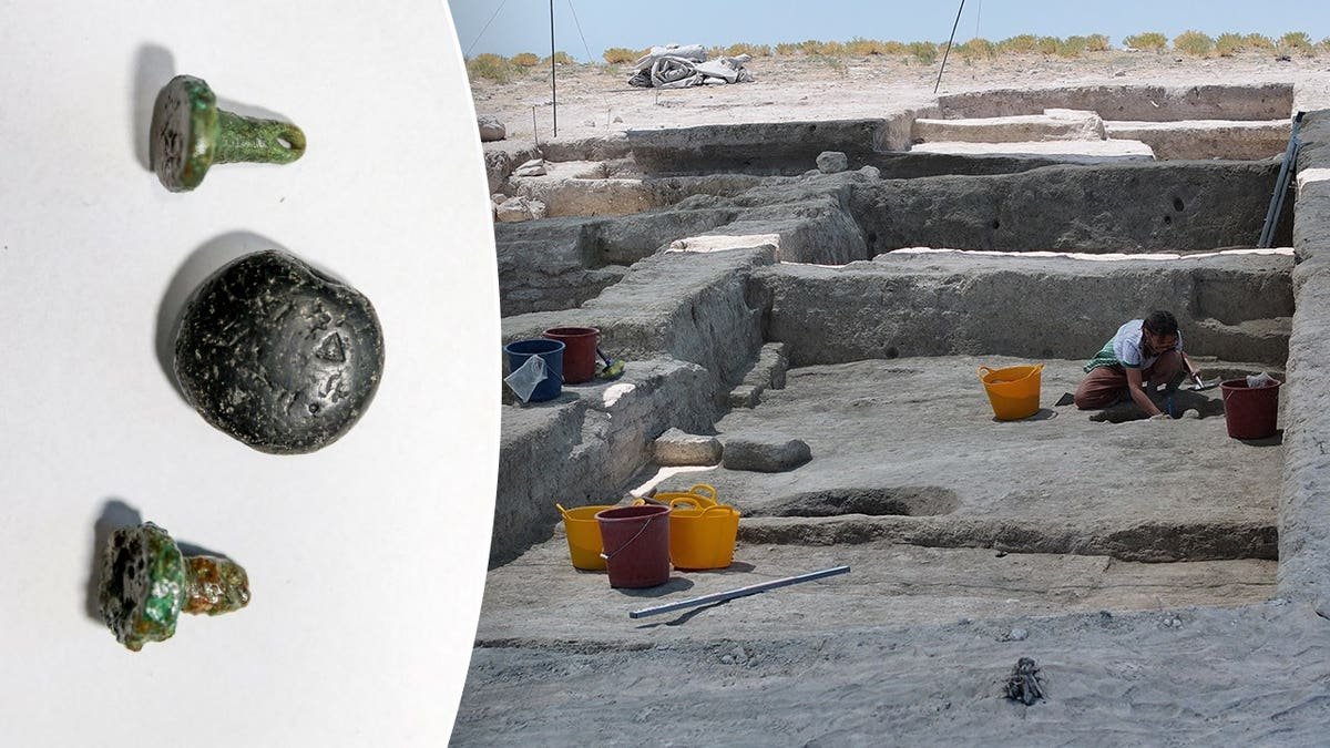 View of ancient artifacts, archaeologists working at dig site