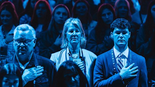 Standing for the national anthem at the AmericaFest convention.