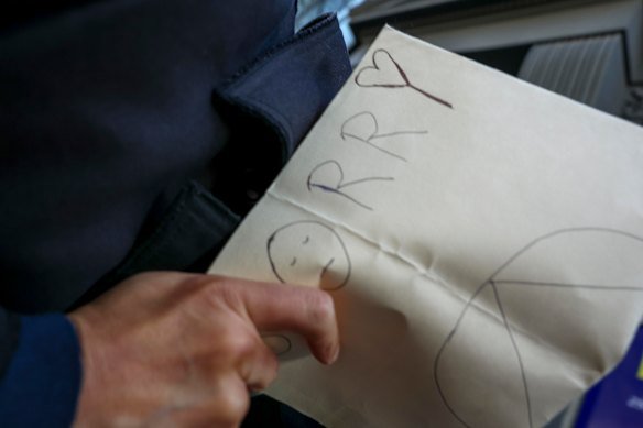 The paper that Nguyen held up outside court read “sorry” on one side.