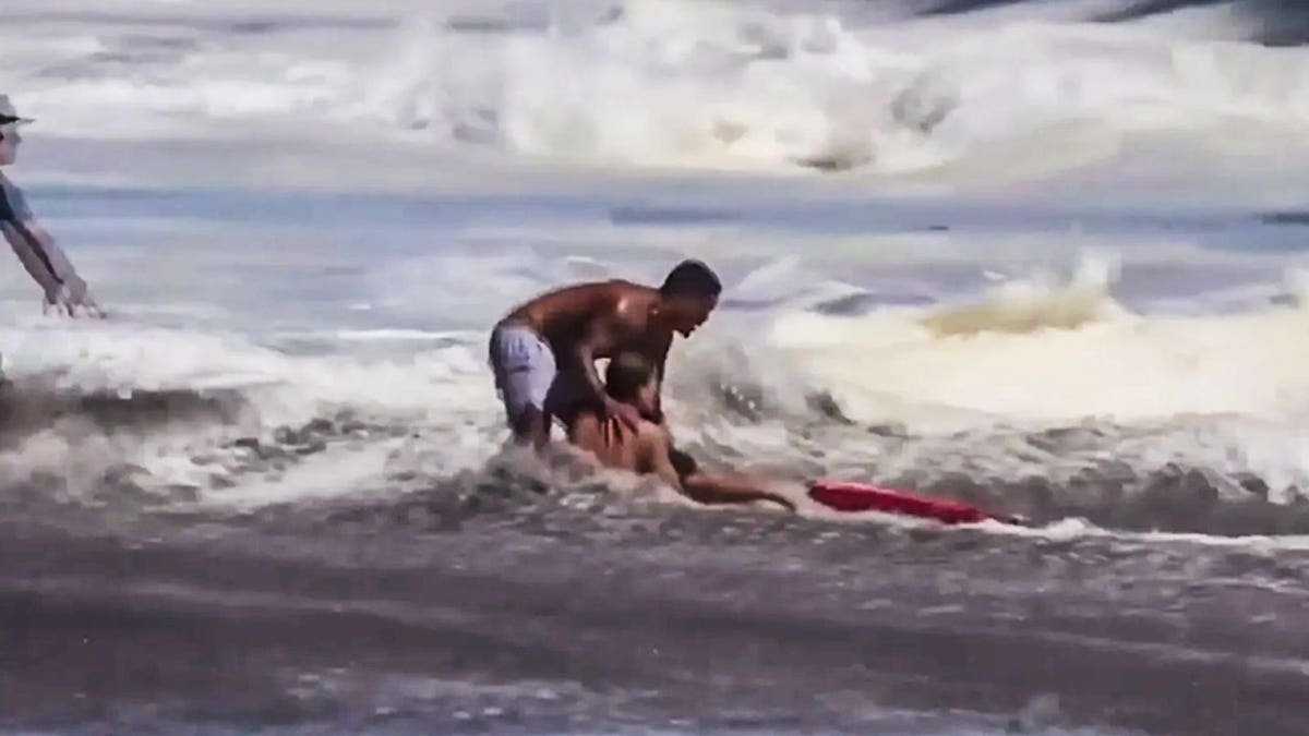 Witnesses say the dramatic rescue lasted far longer than the viral video shows, with the teen lifeguard refusing to release the child despite punishing surf.