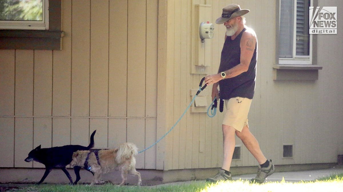 Brian Hooker walks a dog in California.