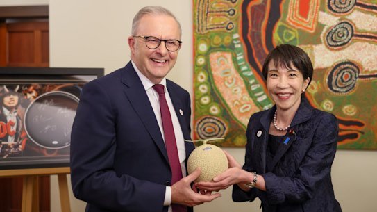 Australian Prime Minister Anthony Albanese accepts a Shizuoka crown melon from Japanese Prime Minister Sanae Takaichi in Canberra in May. 