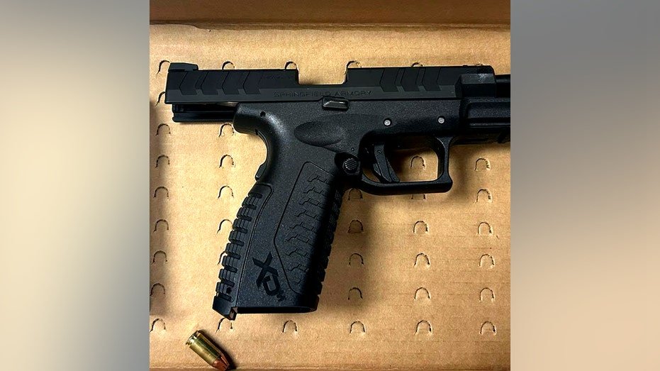 black firearm and bullet on a piece of cardboard