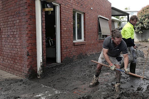Cleaning up in the aftermath of flooding in Maribyrnong in 2022.