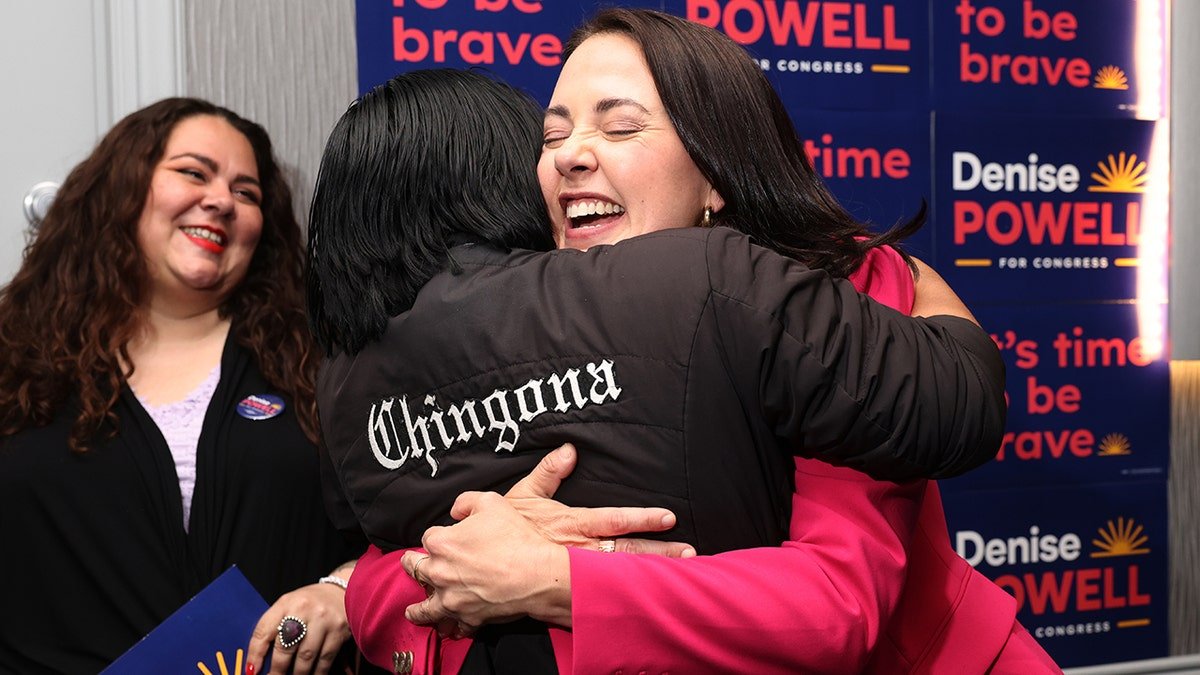 Denise Powell hugs Jennifer Reyna during an election watch party event.
