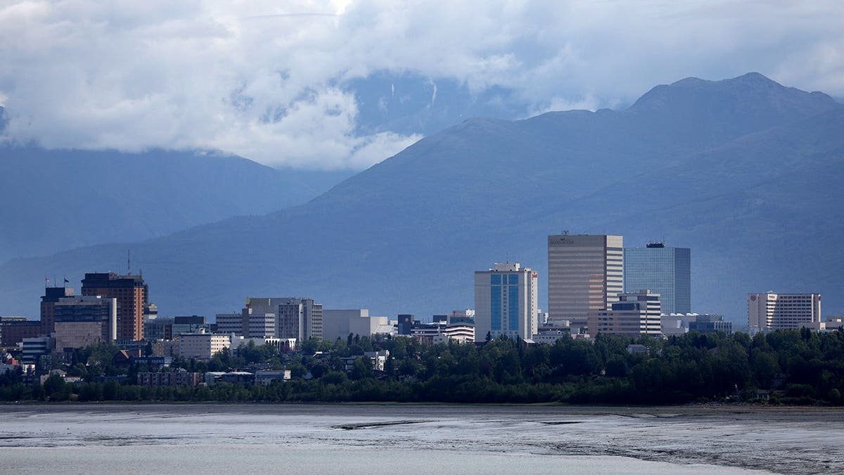 Downtown Anchorage skyline with mountains in the background.