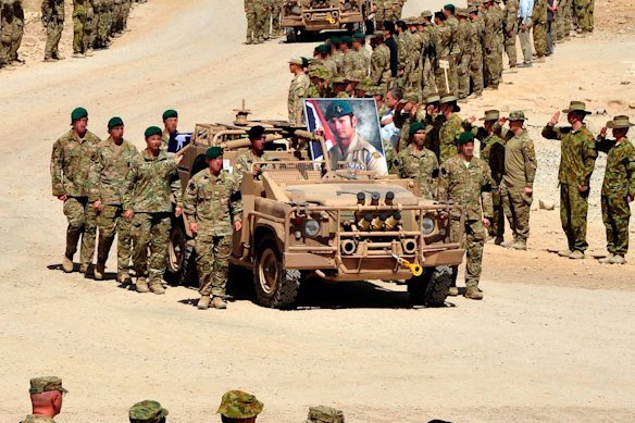 Army vehicles carried Mervyn McDonald, one of five fallen Australian soldiers in August 2012, to the C-130 Aircraft that carried them home.
