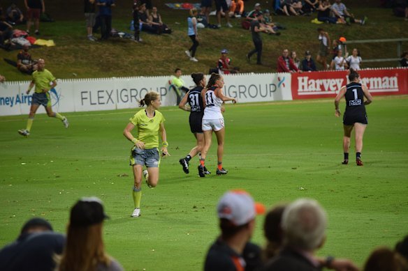 Victoria Rawlings umpiring a game of AFL.