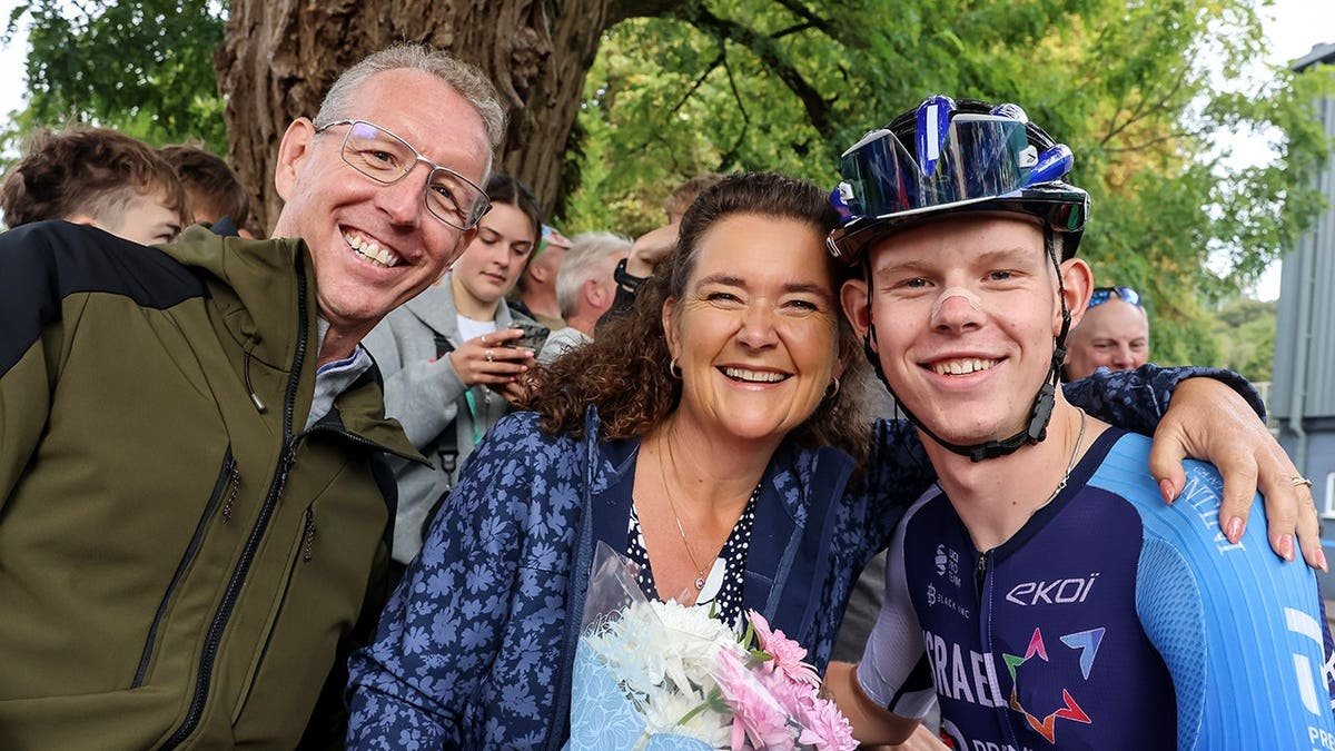 Finlay Tarling presents flowers to his mother before stage 5 of the Tour of Great Britain.