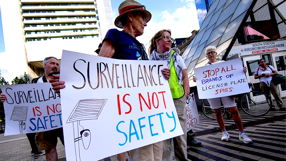 Protesters march against Flock Safety license plate cameras in Boston.