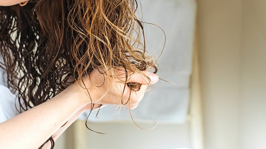 Woman scrunching her hair