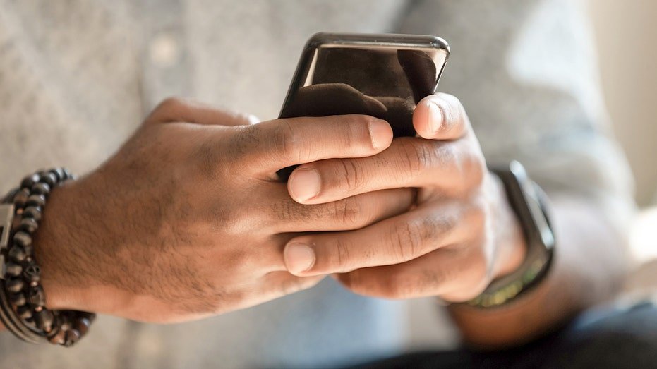 A man holds a smartphone