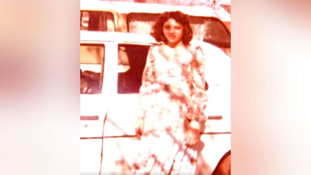 Undated family photo of Lydia Jane Wade McWhorter standing in front of a vehicle