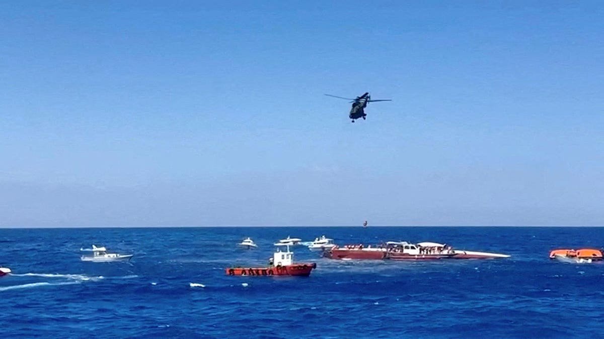 A helicopter rescues a passenger from a capsized ferry off Northern Cyprus.