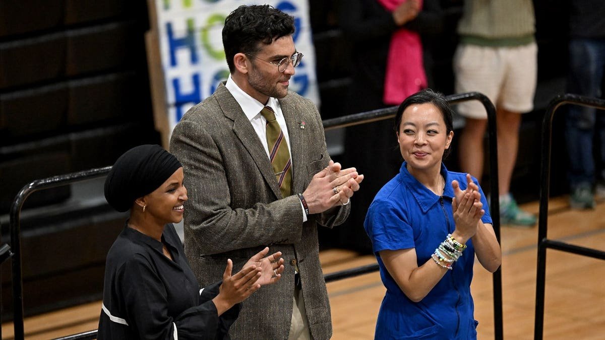 omar, piker, hong at rally clapping