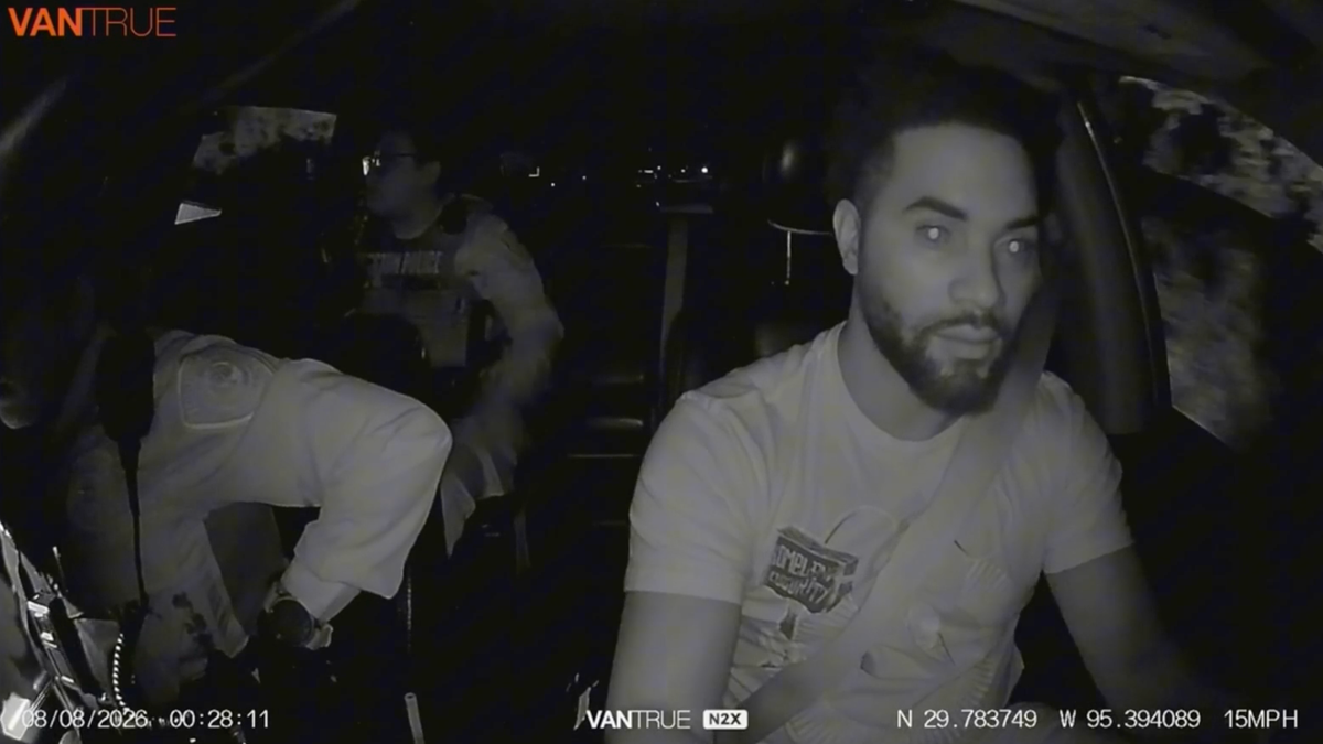Houston Uber driver Anthony Baines drives as two police officers ride in his vehicle during a pursuit captured on dashcam video