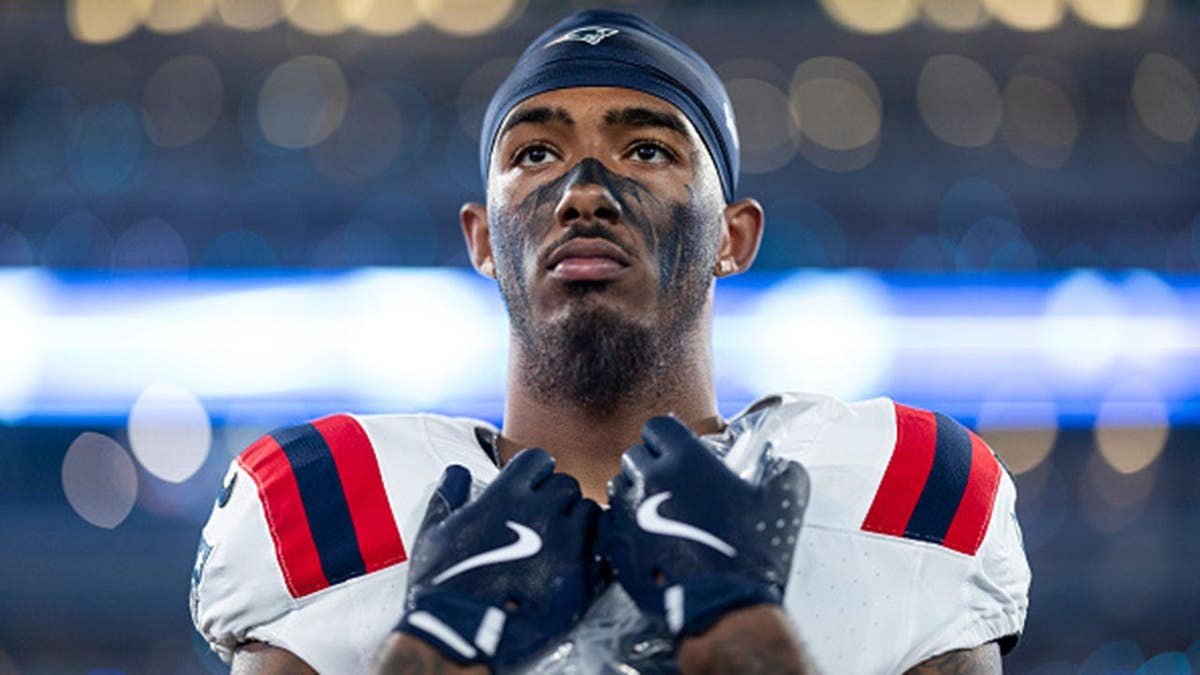 Ja'Lynn Polk of the New England Patriots looks on during the national anthem.
