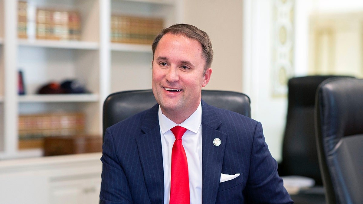 VA AG Jason Miyares poses for a photo in office