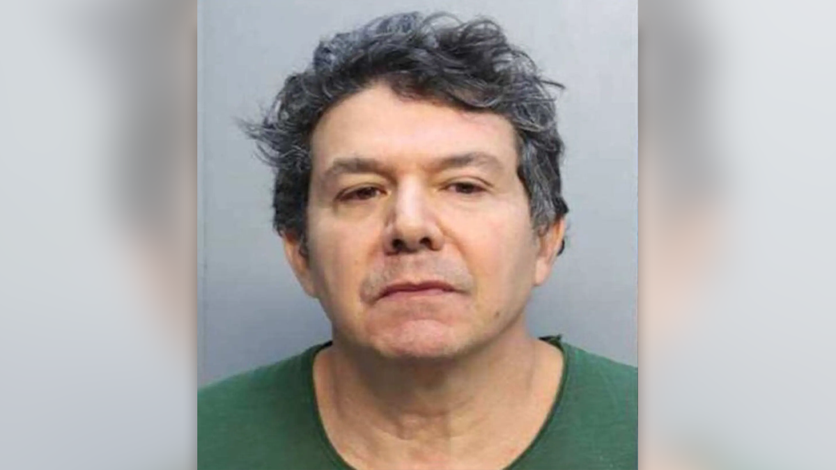 Joao Araujo wearing a green shirt, clean shaved and with dark, wavy hair in a mugshot photo
