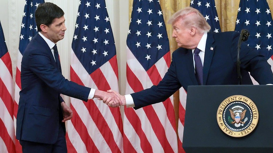 Kevin Warsh and Donald Trump shake hands