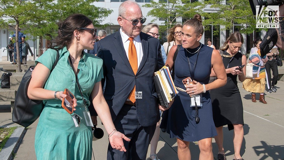 Brittany Romano leaves Plymouth Superior Court alongside Lindsay Clancy's attorney, Kevin Reddington, in Plymouth, Mass., Monday, August 24, 2026. Romano is a reporter for Vanity Fair covering the Lindsay Clancy trial.