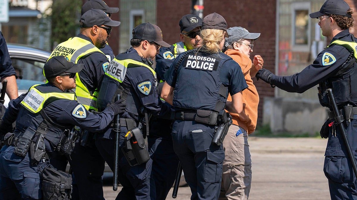 Madison police officers arrest a protester near the former Corey Ruiz protest encampment in Madison, Wisconsin.