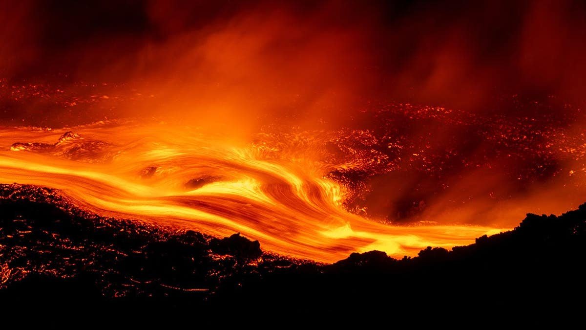 Lava flows descend Mount Etna's slopes near Catania, Italy.