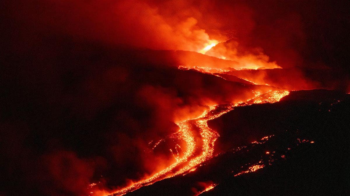 Mount Etna emits lava flows down the volcano slopes near Catania, Italy.