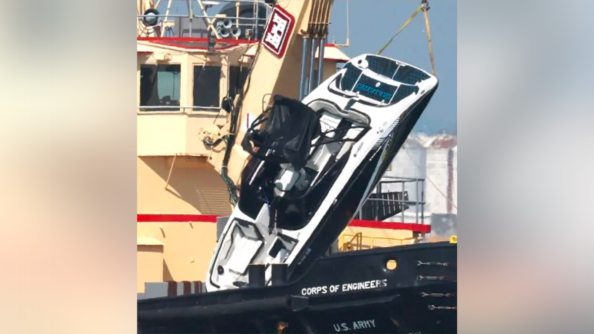 Crane lifting the capsized Yamaha AR210 from New York Harbor following the fatal accident