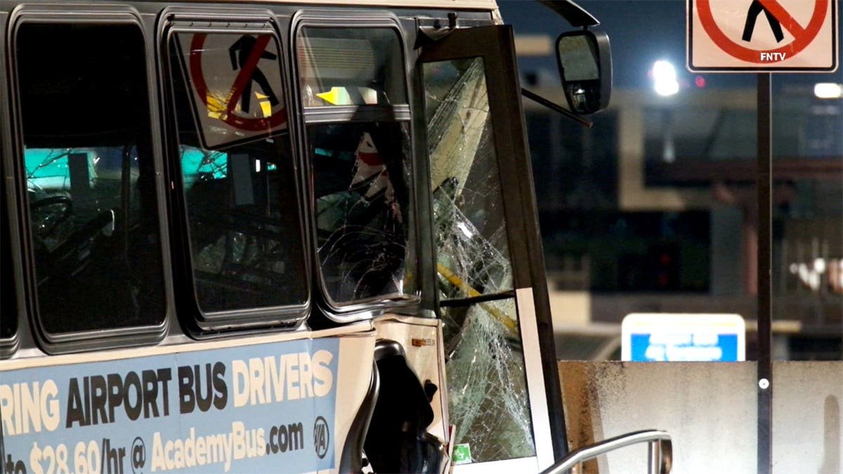 a close up of the shattered glass windows of damaged shuttle bus