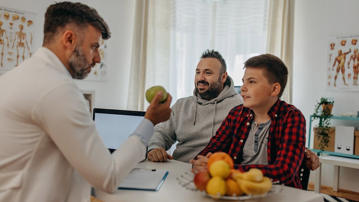 obese child at doctor's with father