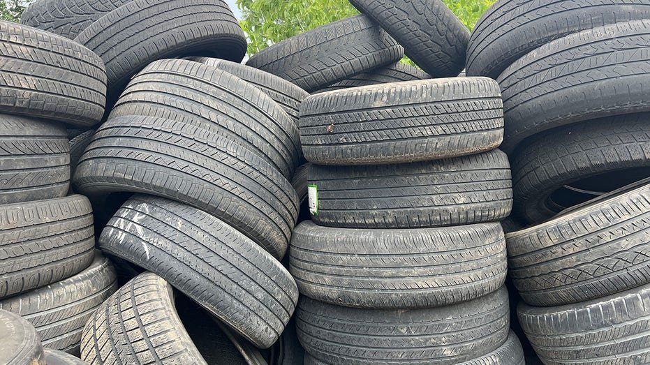Used vehicle tires piled outside an auto repair shop in Toronto.