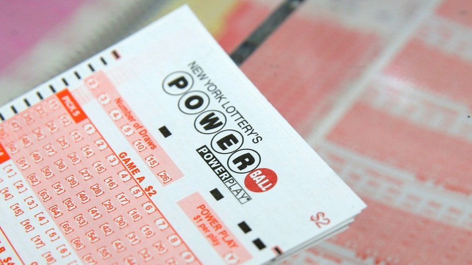 A ticket for the Powerball lottery sits on a counter in a store