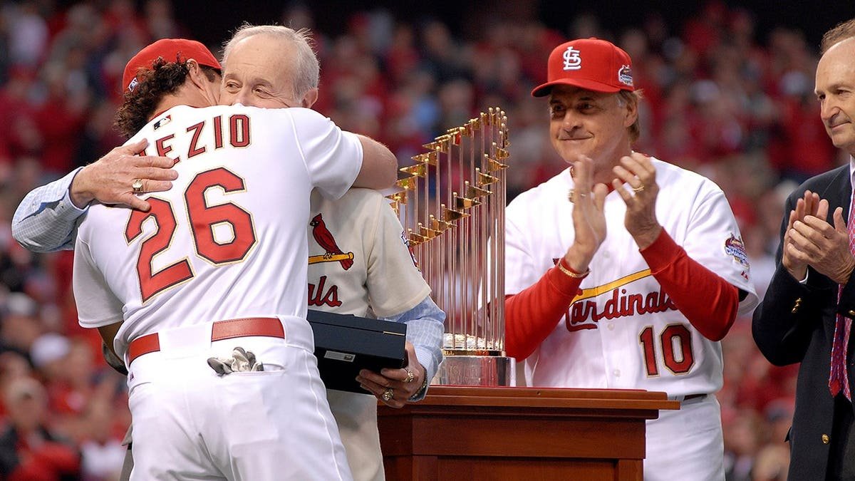 Scott Spiezio receives his World Series ring from his father Ed during a ceremony at Busch Stadium.