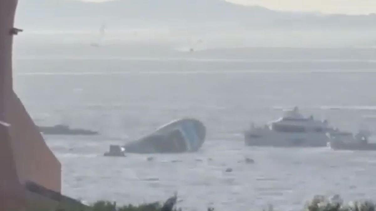 A superyacht rolls onto its side as it sinks in the Mediterranean Sea.