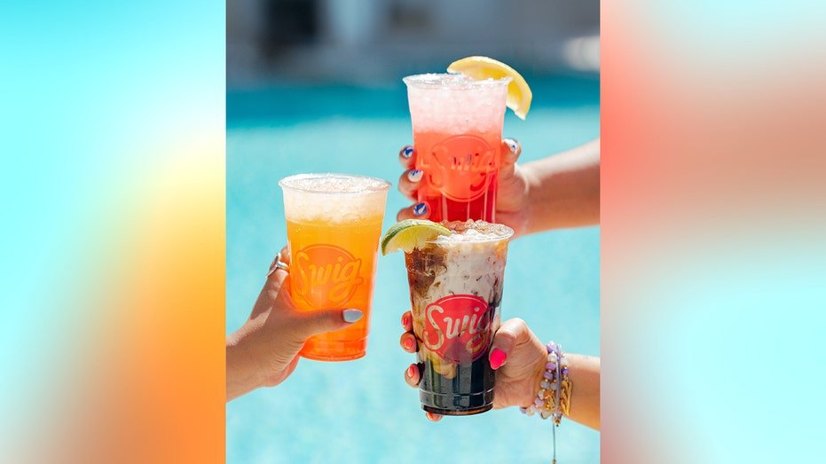 Swig beverages are shown near a swimming pool